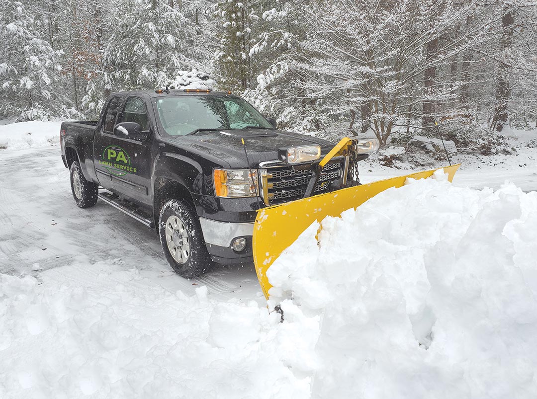 A residential property being cleared of snow